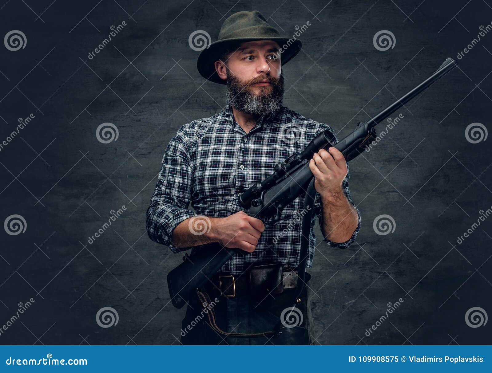 a hunter holds a rifle.