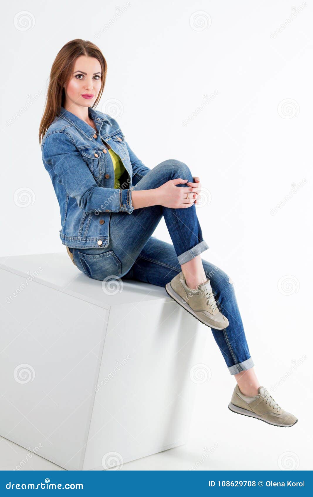 Studio Portrait of Beautiful Young Smiling Woman Wearing Blue Jeans and ...