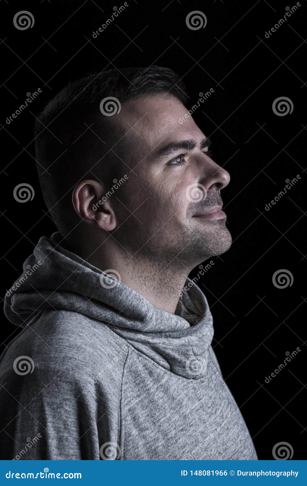 Studio Portrait of a Man Looking Up. Black Background. Stock Photo