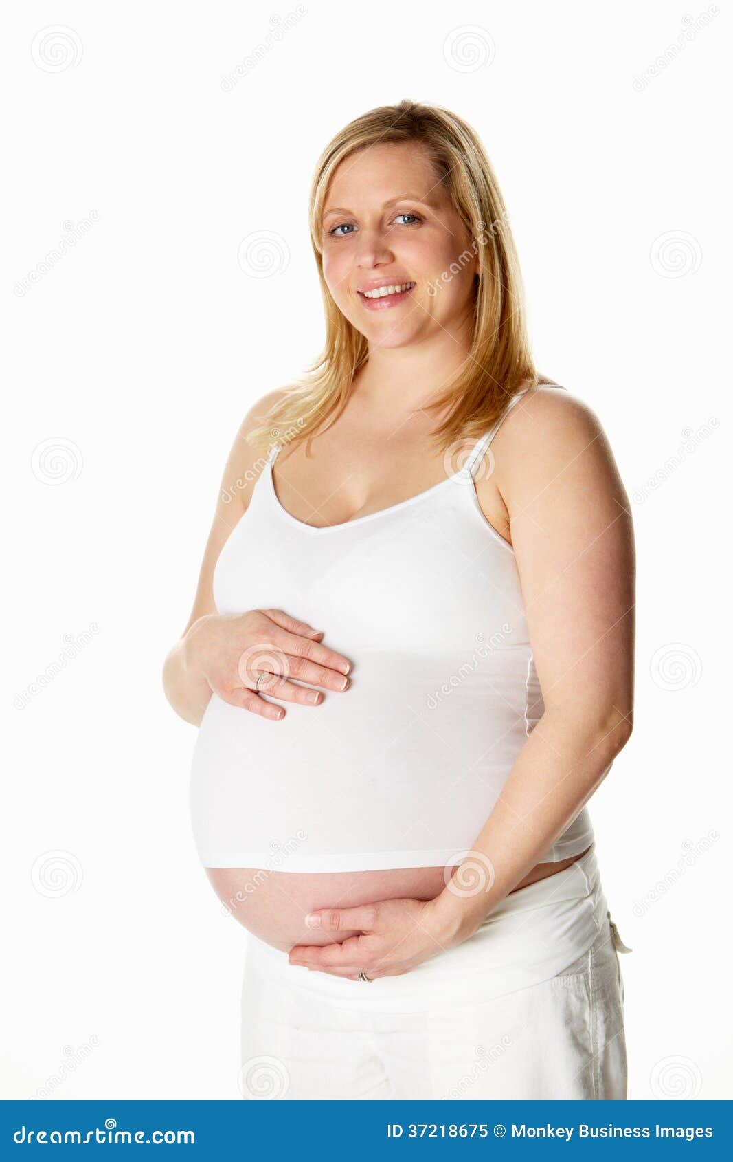 Studio Portrait of 8 Months Pregnant Woman Wearing White Stock Image
