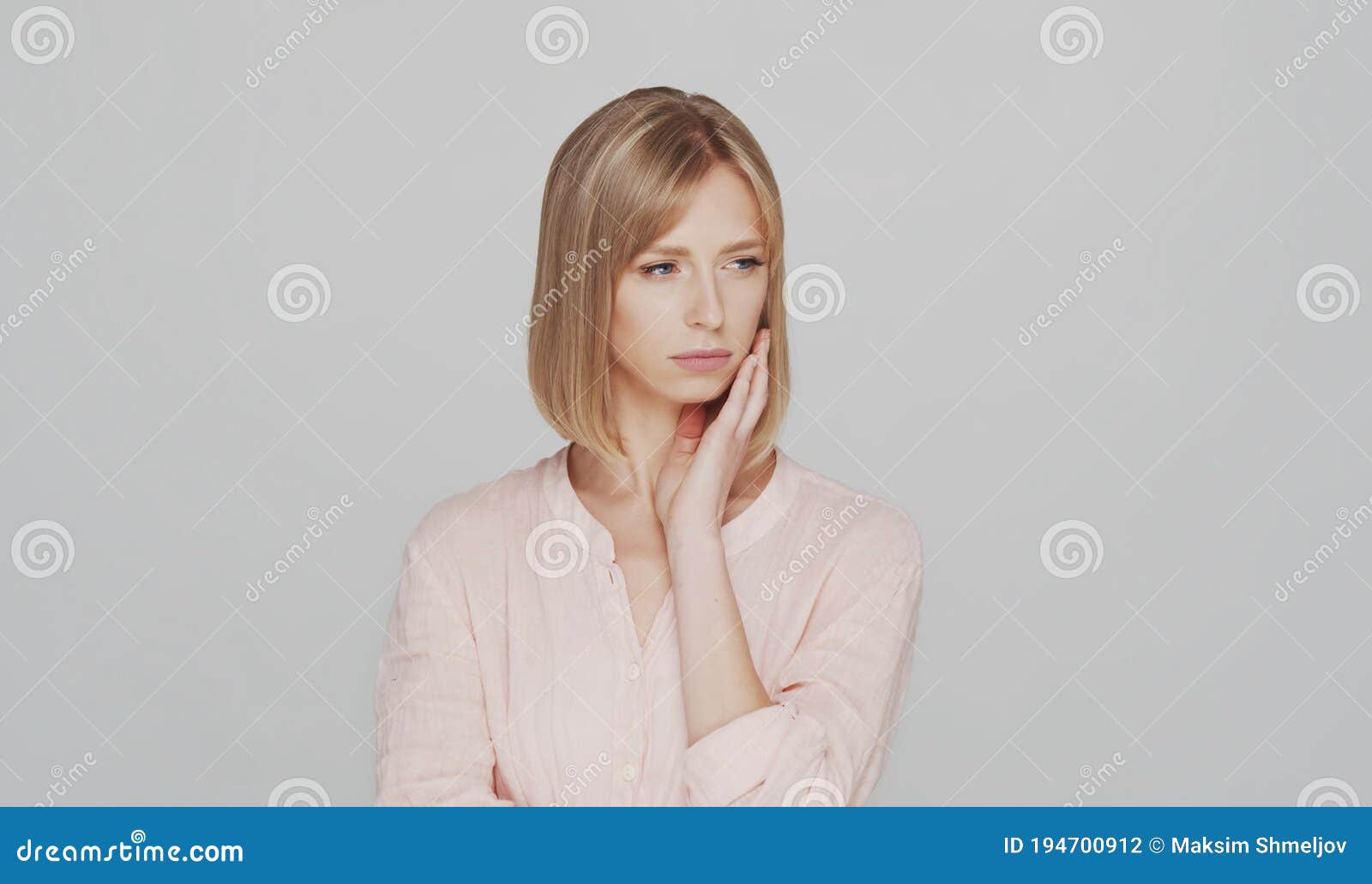 studio portrait of sad and depressive young blond woman.