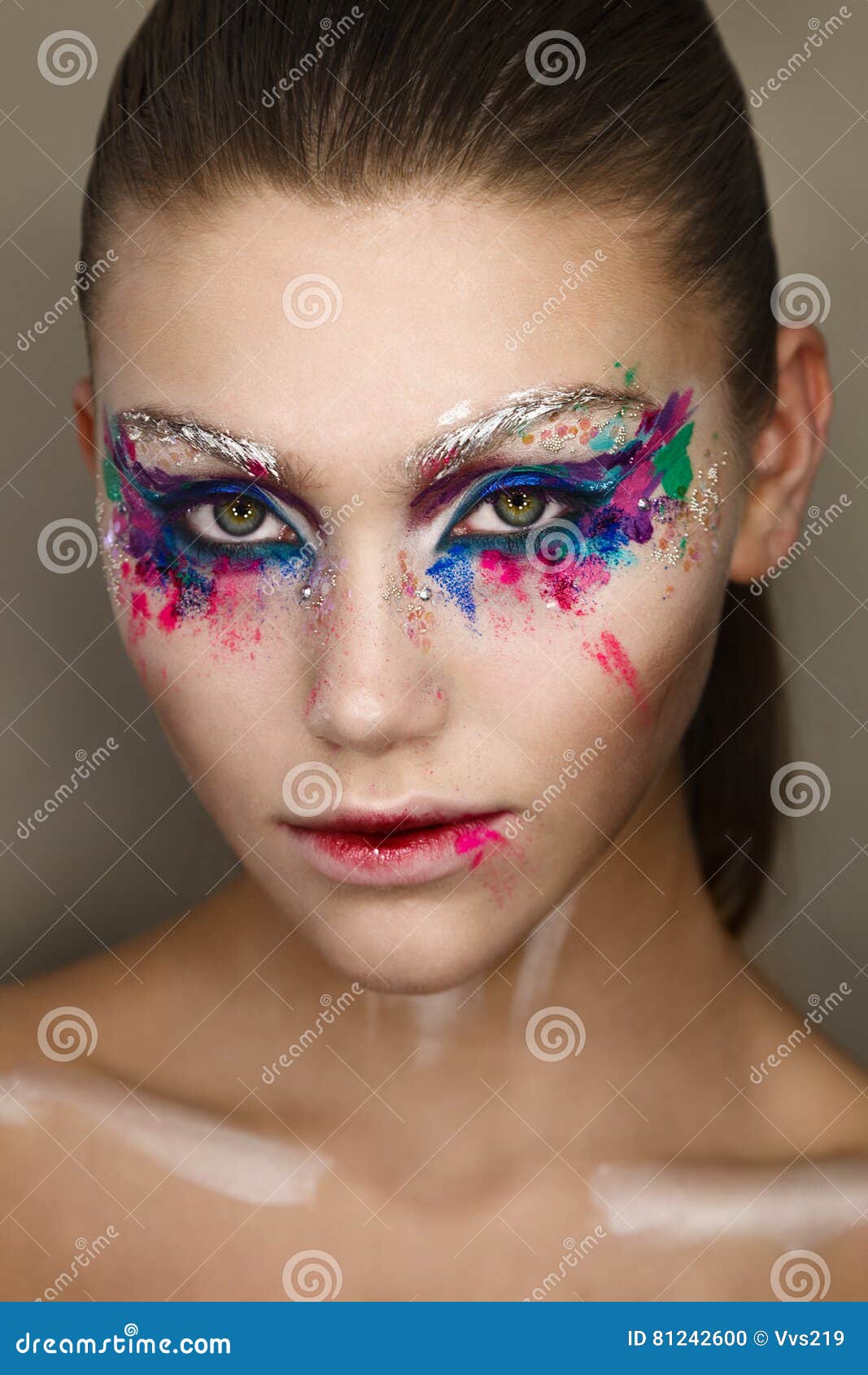 studio portrait of young beautiful woman with creative colorful makeup