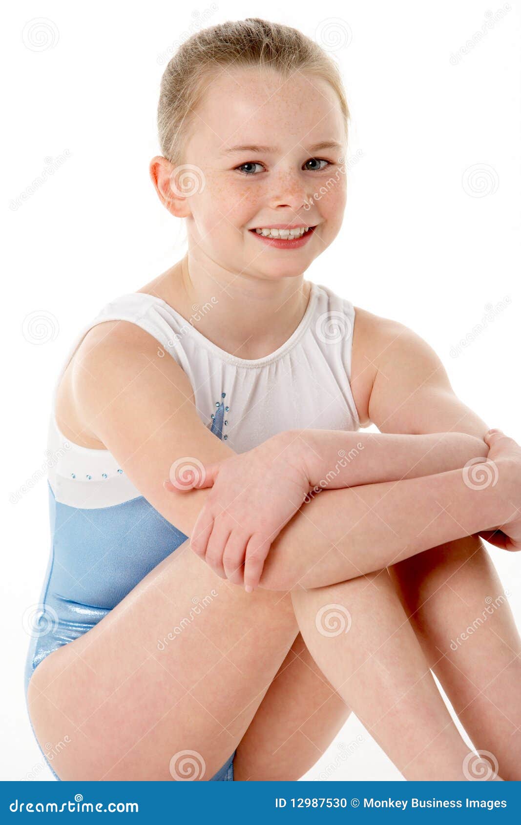 Portrait Of A Young Female Gymnast Performing Over Blue 