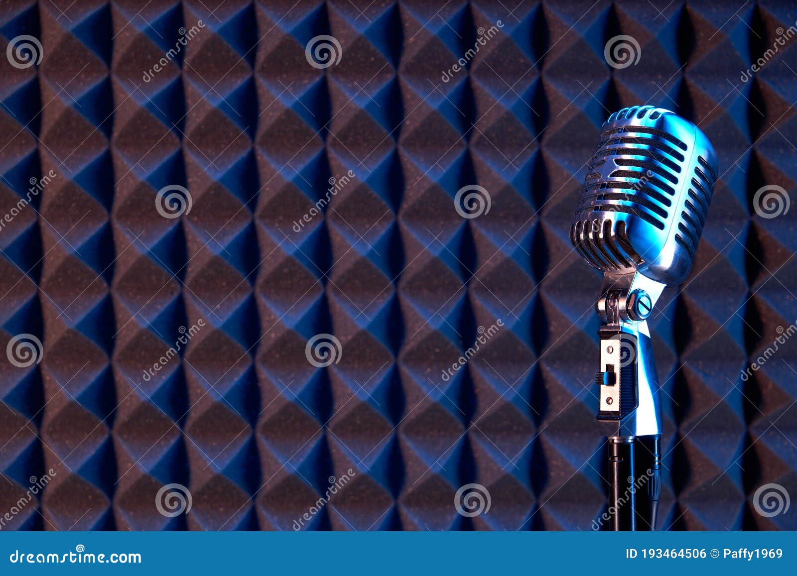 Studio Retro Condenser Microphone on Acoustic Foam Panel Editorial