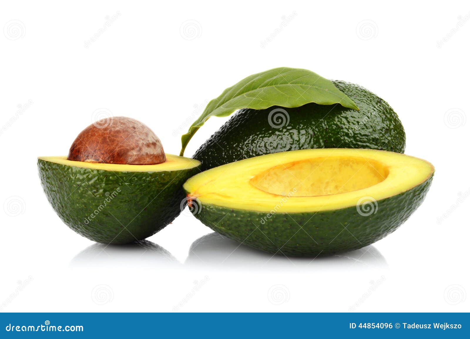 studio shot of avocado with leaf and pit core 
