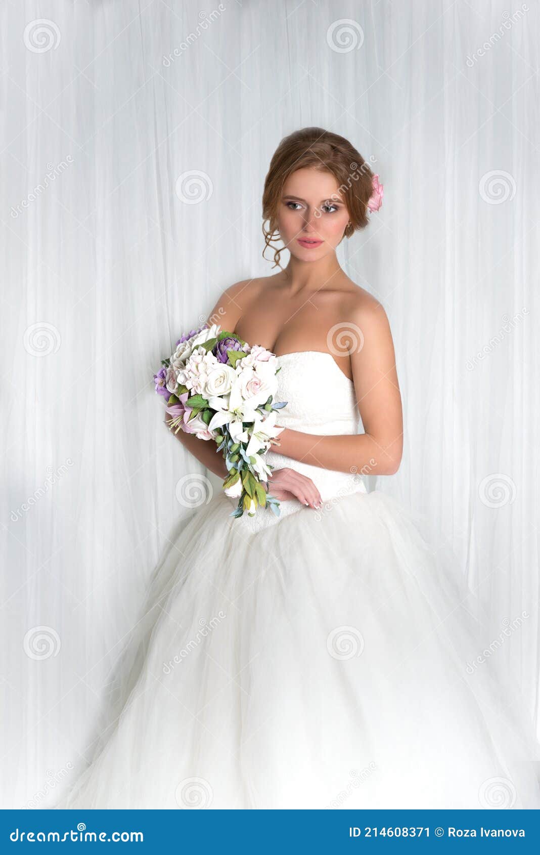 studio shot of the bride with a bouquet of flowers