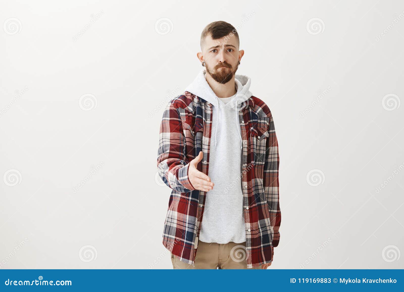 Studio Shot of Gloomy Unconfident European Guy with Fair Hair in Trendy Plaid Shirt Over Hoodie, Pulling Towards Stock - Image of advertising, emotional: 119169883