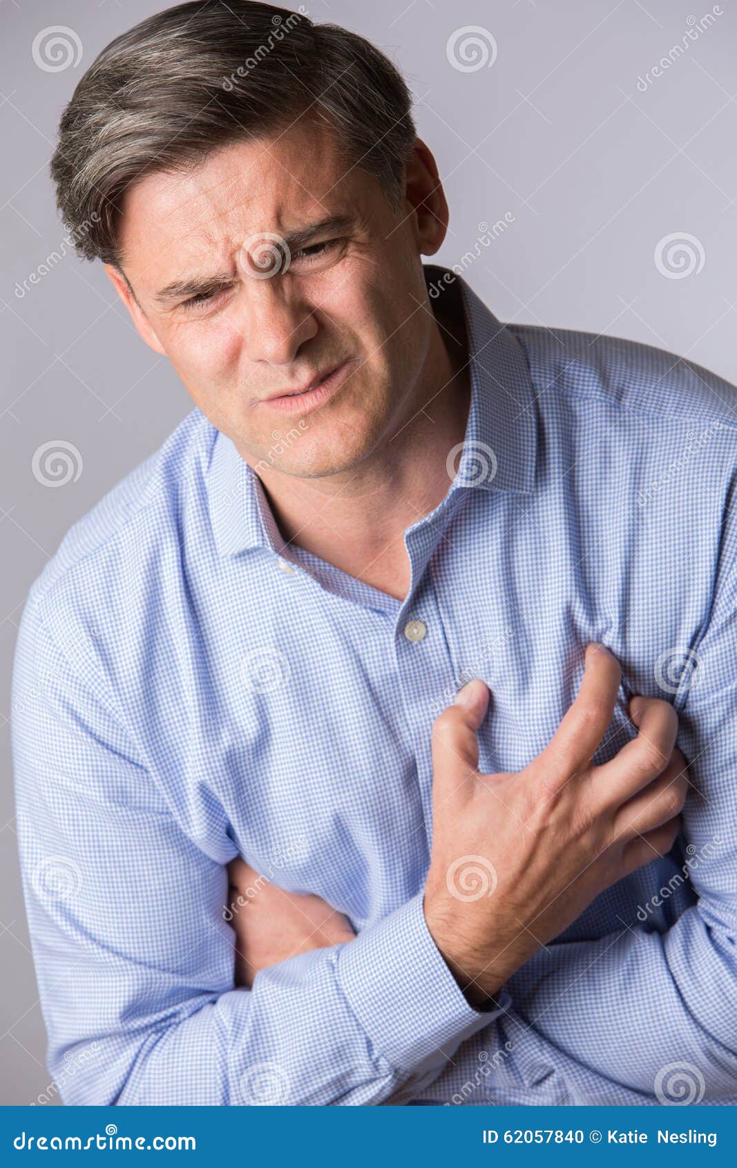 Studio Shot of Mature Man Suffering Heart Attack Stock Photo - Image of ...