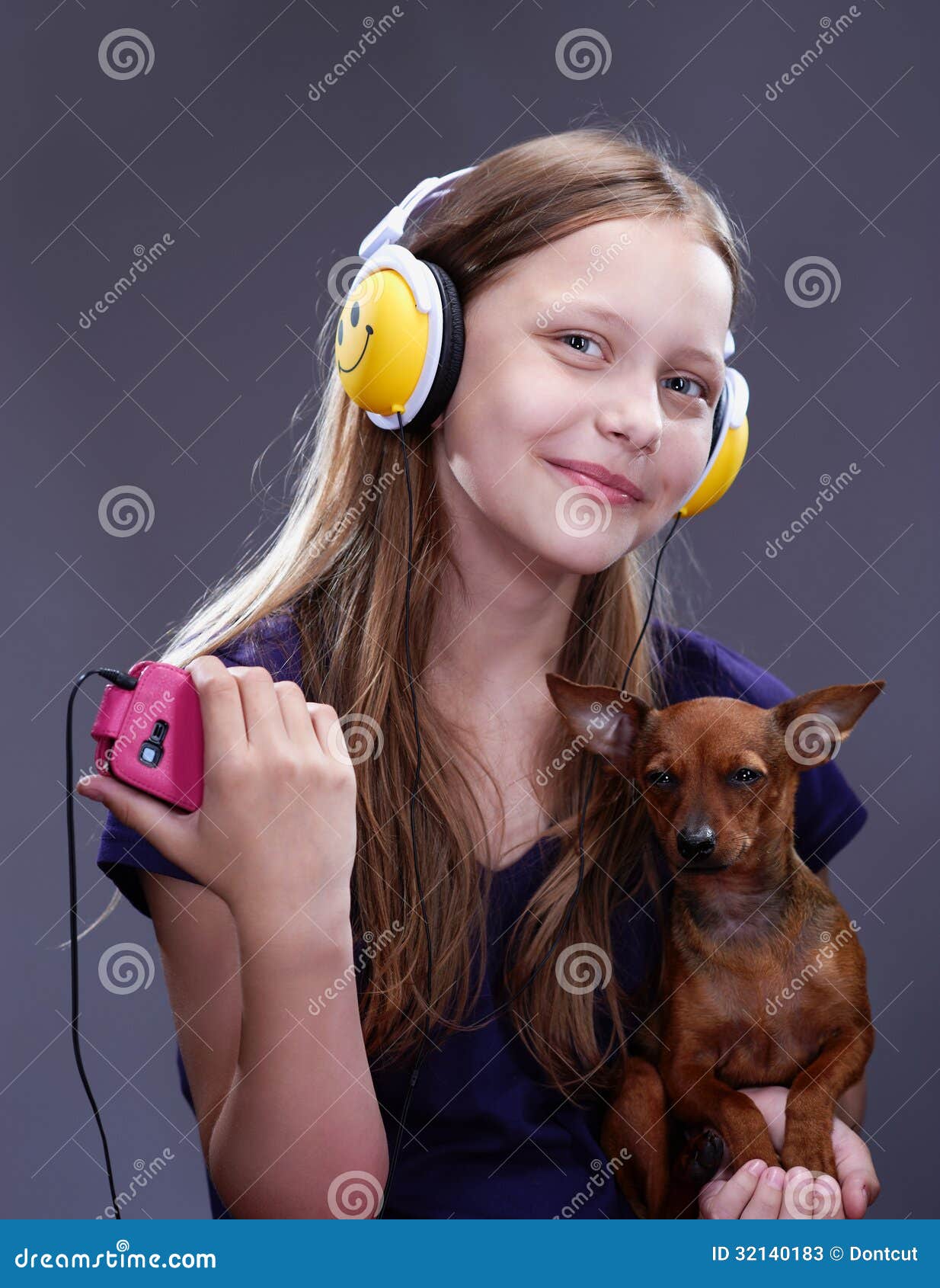 Studio Shot Of A Smiling Teen Girl With Headphones And Do