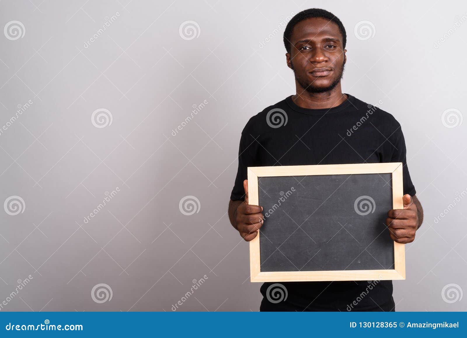 Young African Man Wearing Black Shirt Against Gray Background Stock ...