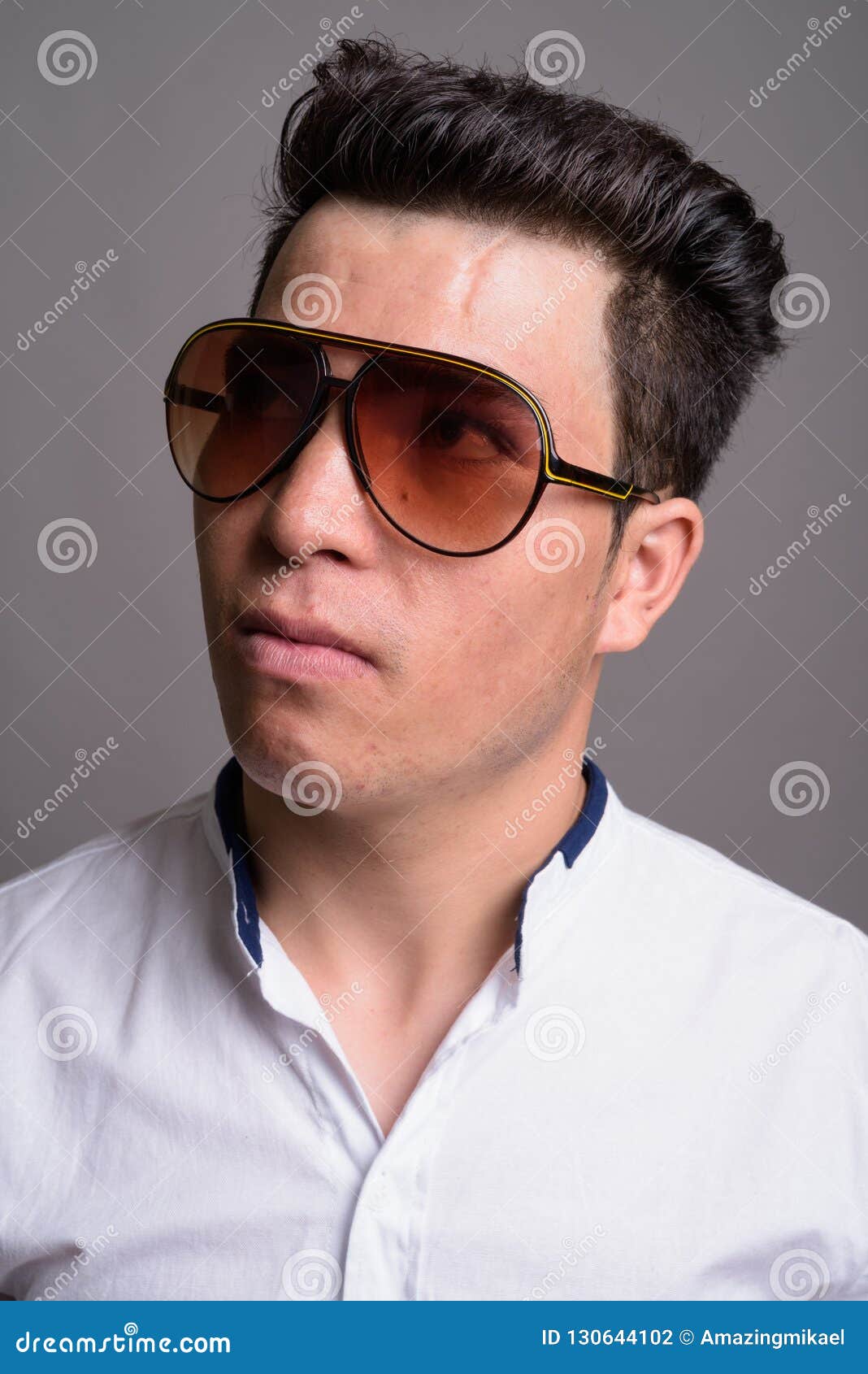 Young Asian Businessman Wearing Sunglasses Against Gray Backgrou Stock ...