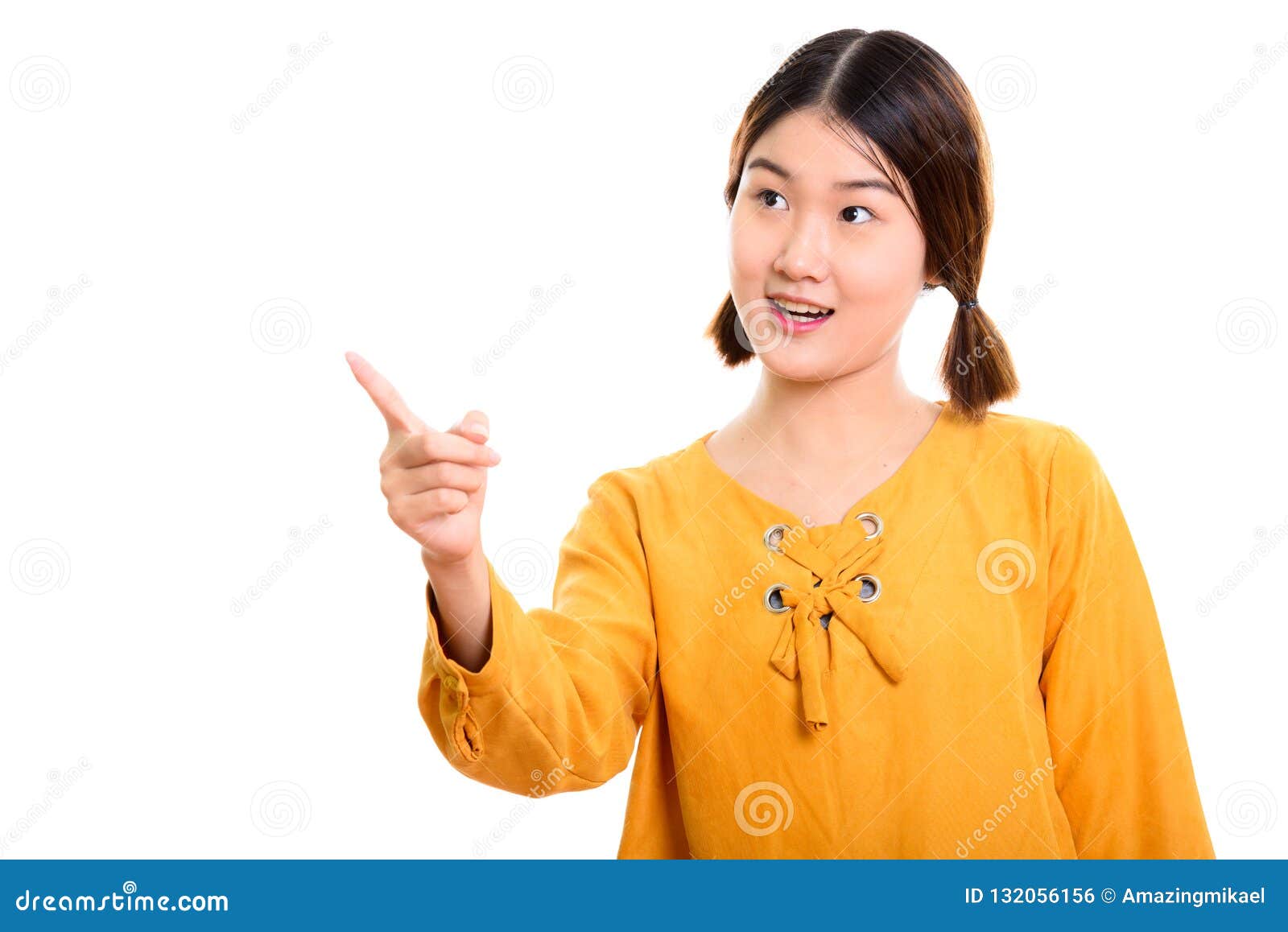 Studio Shot Of Young Beautiful Asian Woman Pointing Finger At Di Stock
