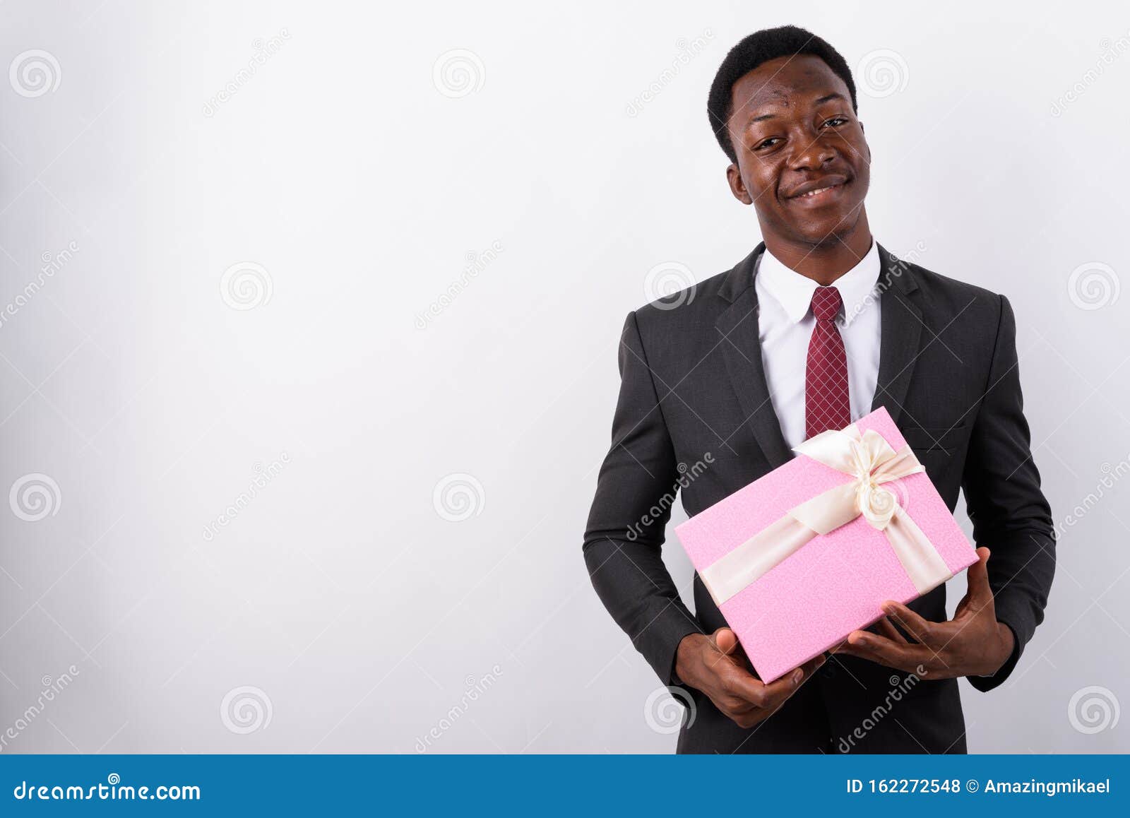 Young Handsome African Businessman Holding Gift Box Against Whit Stock ...