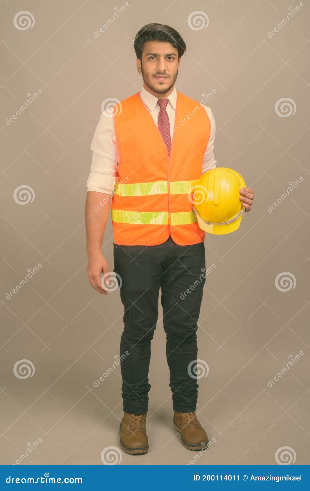 Young Handsome Indian Man Construction Worker Against Gray Background ...
