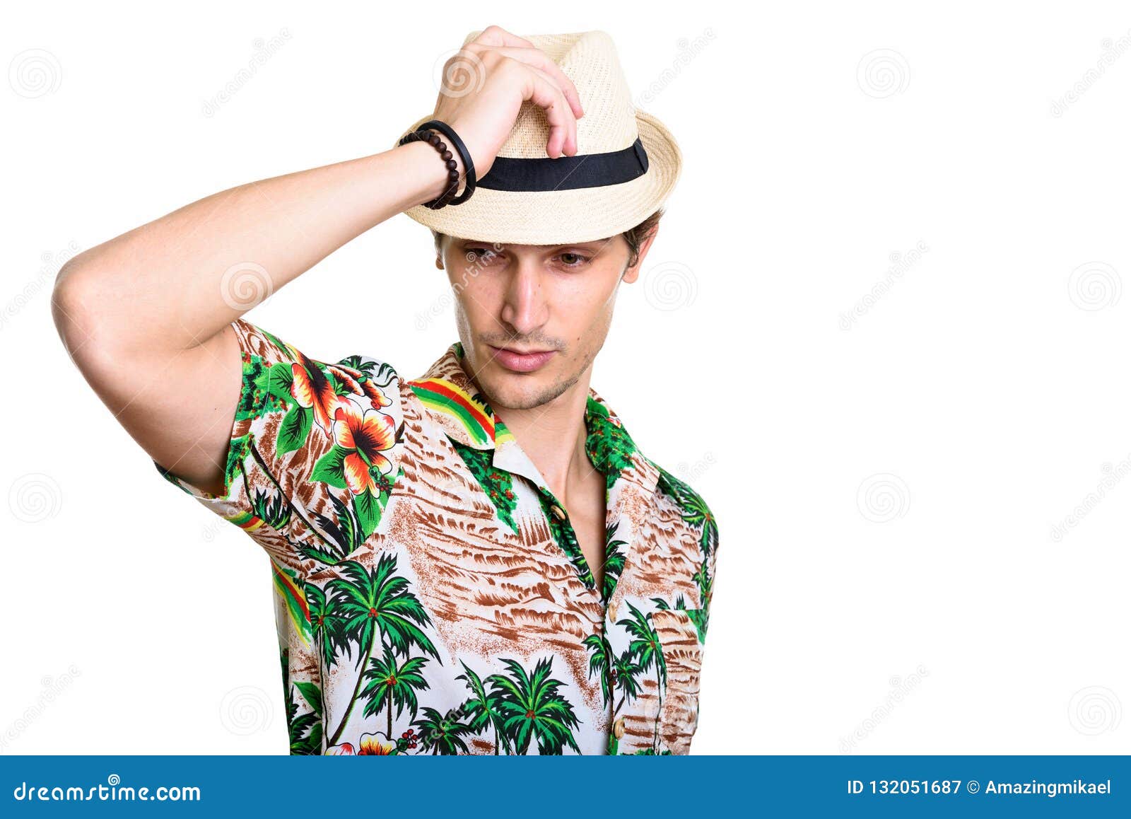 Studio Shot of Young Handsome Man Posing while Holding Hat Stock Image ...