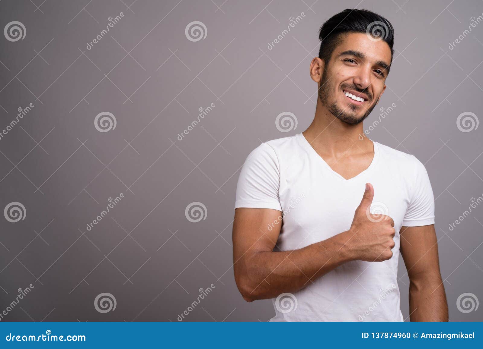 Young Handsome Persian Man Against Gray Background Stock Photo - Image ...