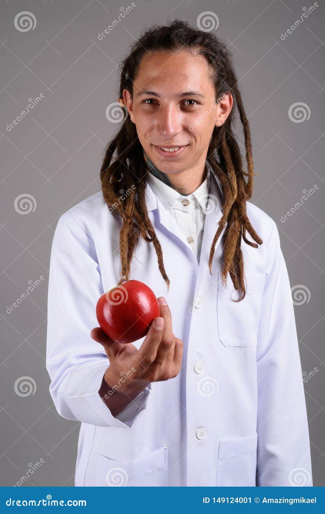 Young Man Doctor with Dreadlocks Against Gray Background Stock Image
