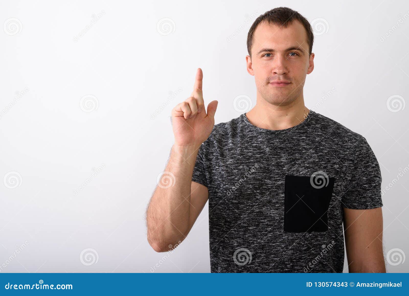 Studio Shot Of Young Muscular Man Pointing Finger Up Against Whi Stock ...