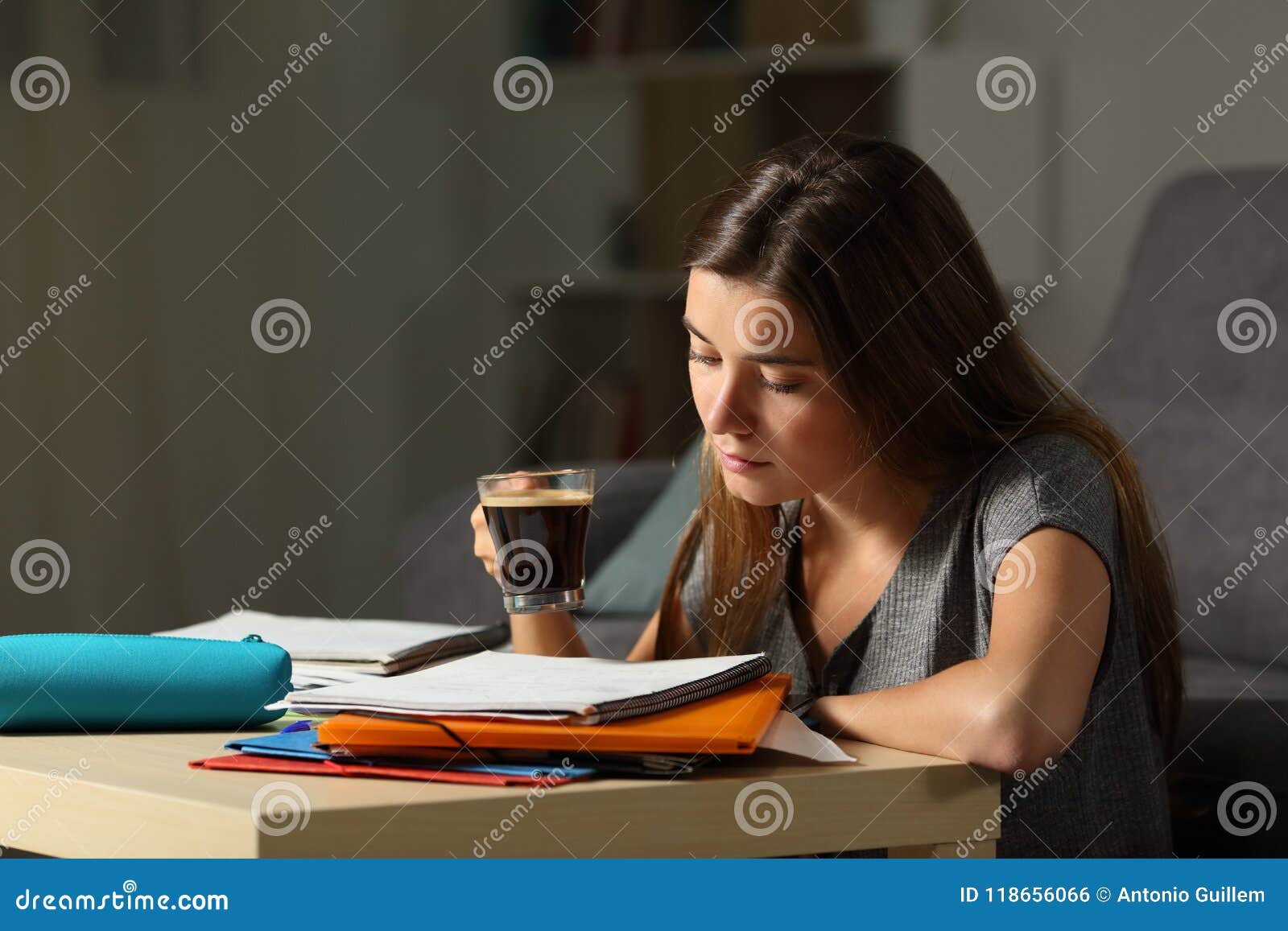 studious student studying holding a coffee cup