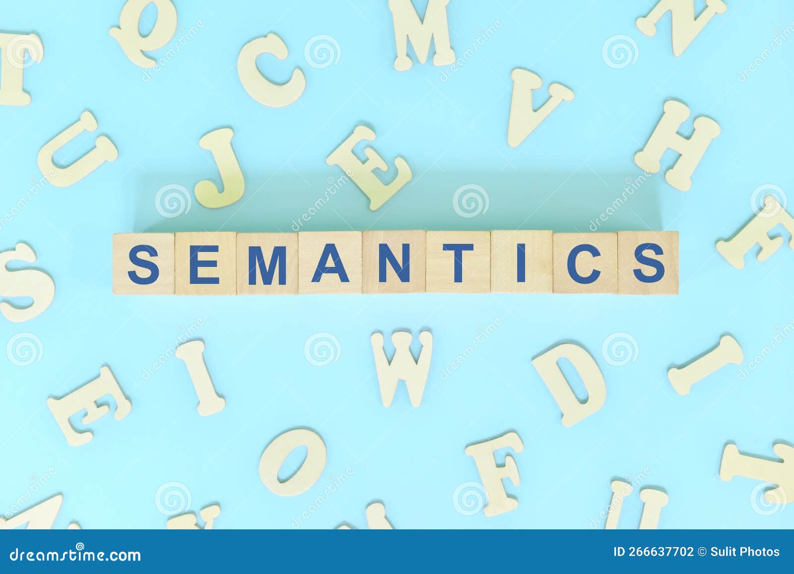 study semantics in linguistics concept. wooden blocks word typography flat lay in blue background.