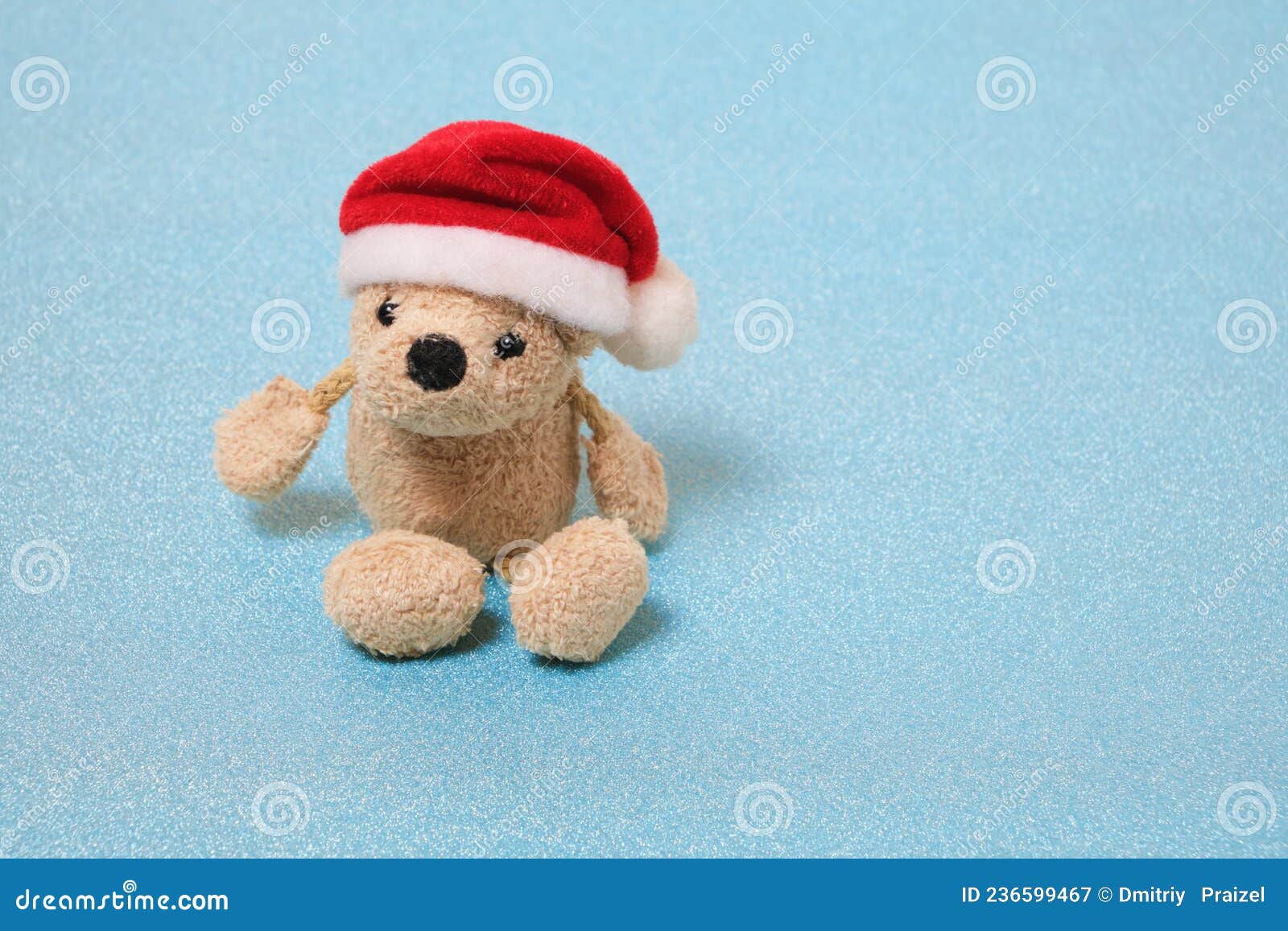 Stuffed Teddy Bear in a Santa Claus Hat on a Blue Background Stock ...