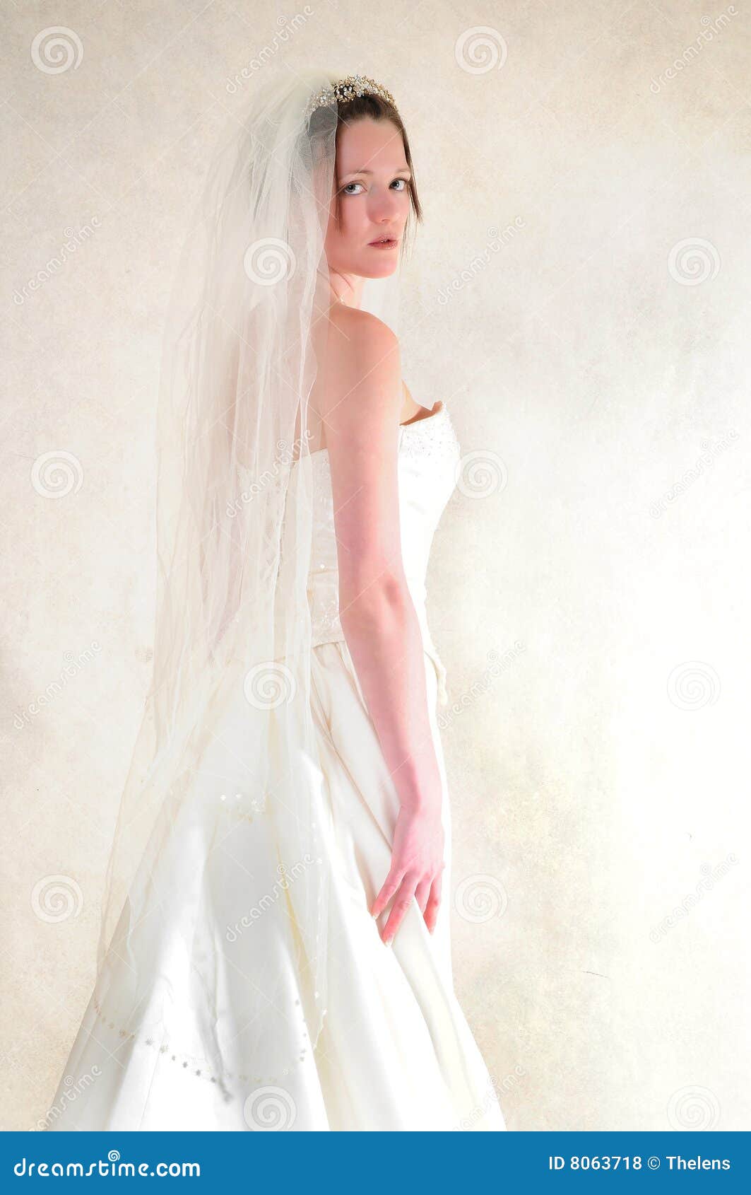 Stunning bride. Lovely bride standing in her full wedding gown looking at the camera