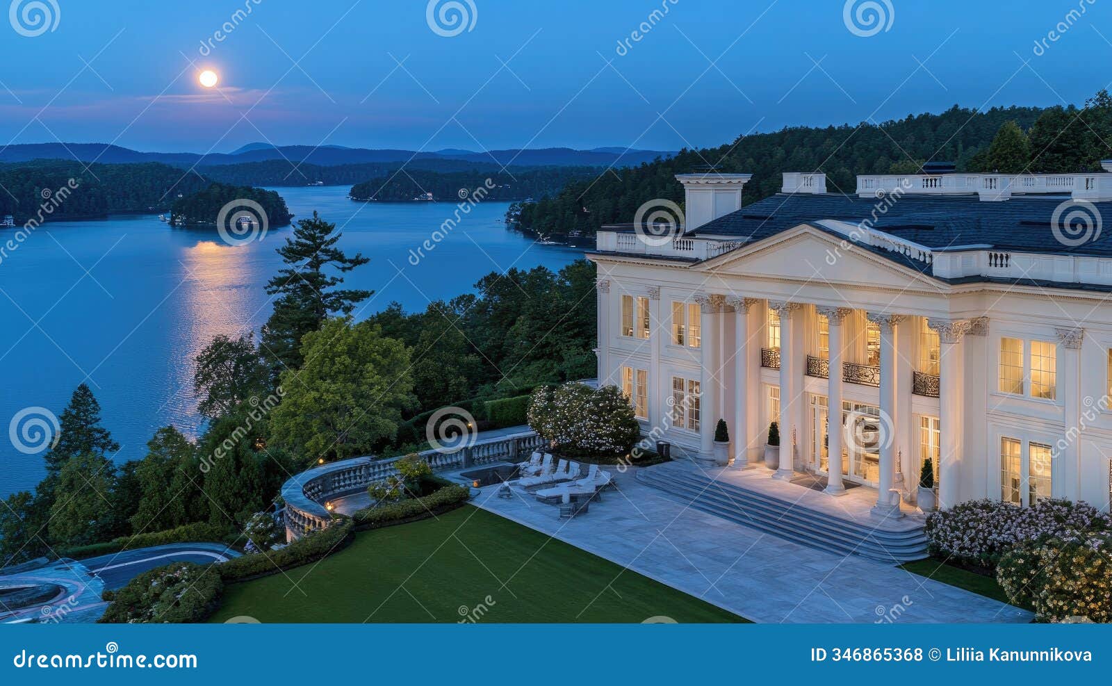 stunning property on lake keowee in georgia featuring a large patio, columns, and a full moon illuminating the tranquil