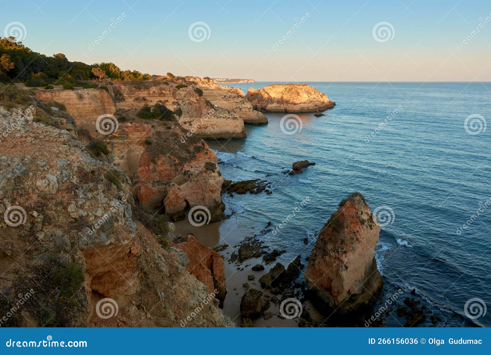 stunning sunset view of the secluded beach and colorful cliffs. algarve region, portugal
