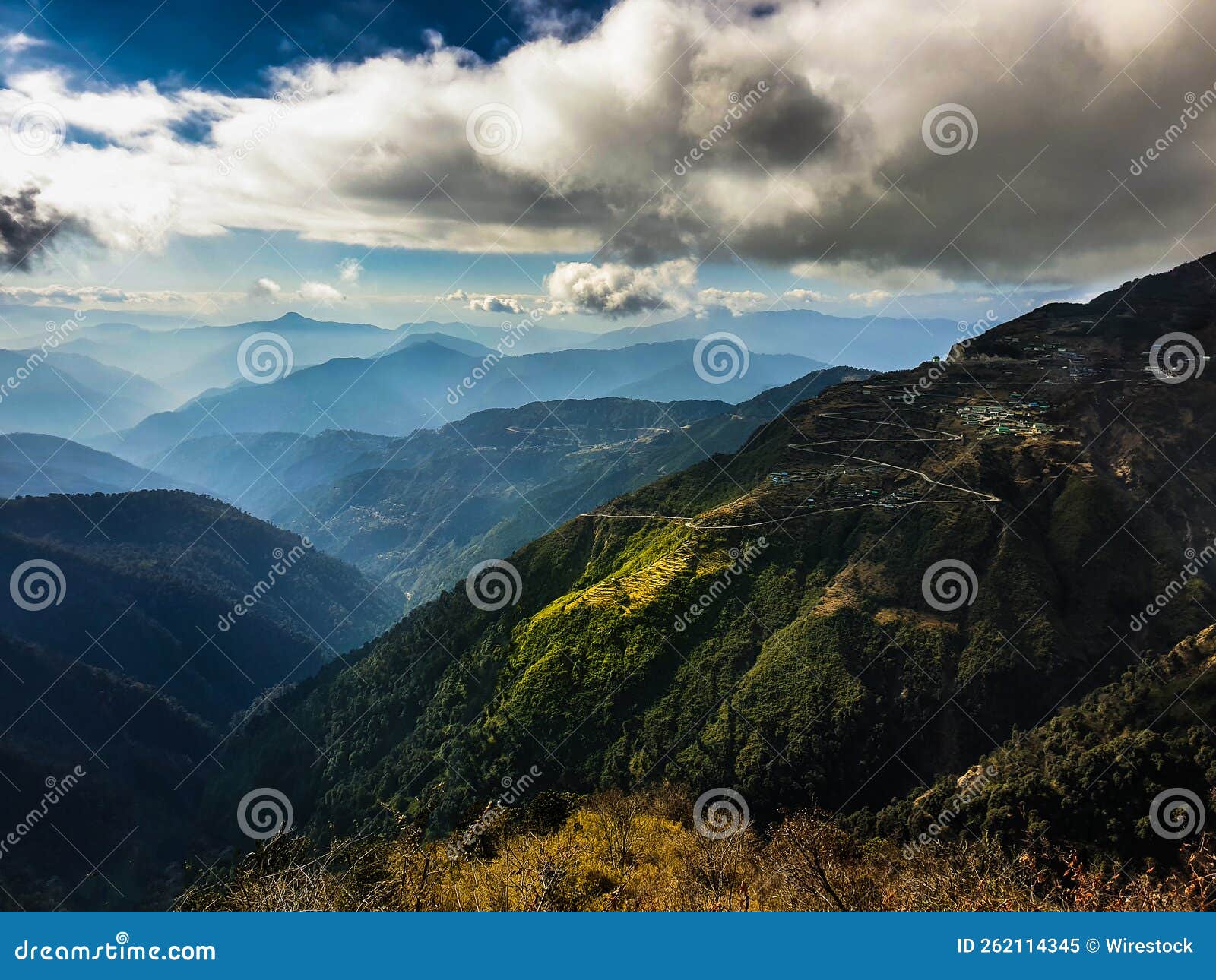 stunning view of layered mountain ranges under a cloudy sky near lake tsomgo