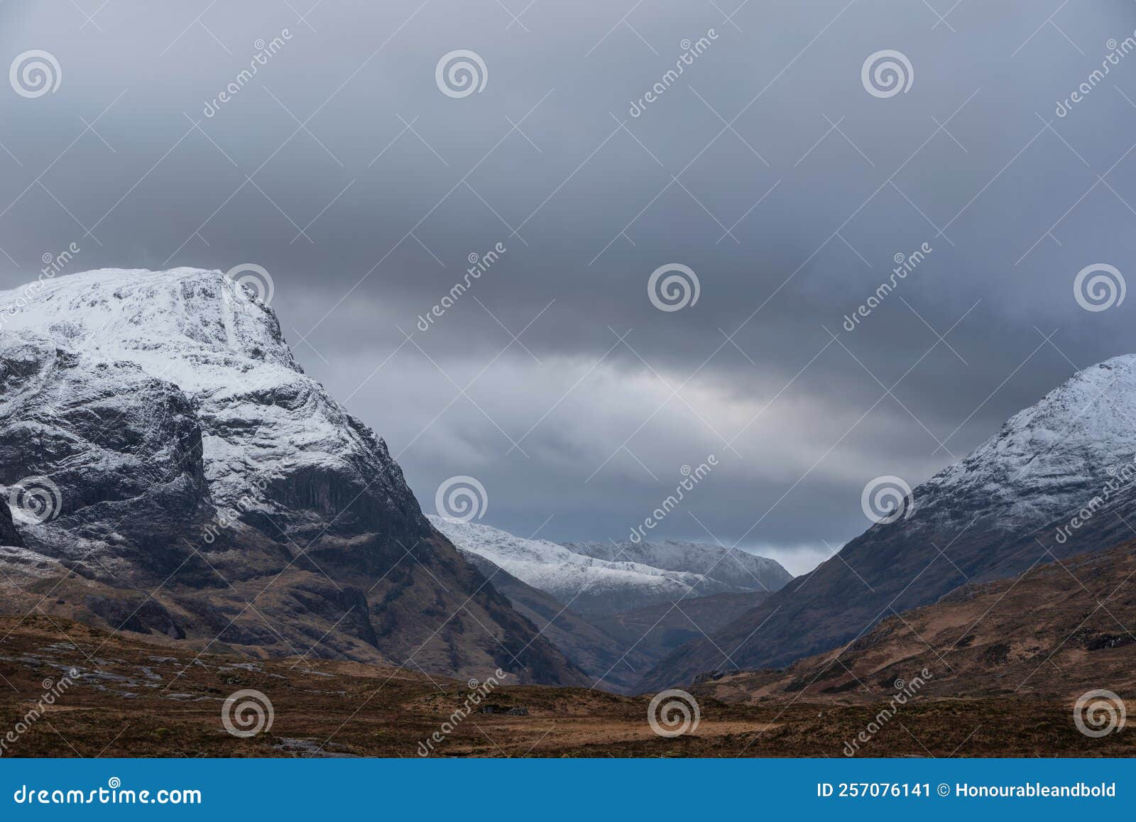 stunning winter landscape image of snowcapped three sisters mountain range in glencoe scottish highands with dramatic sky