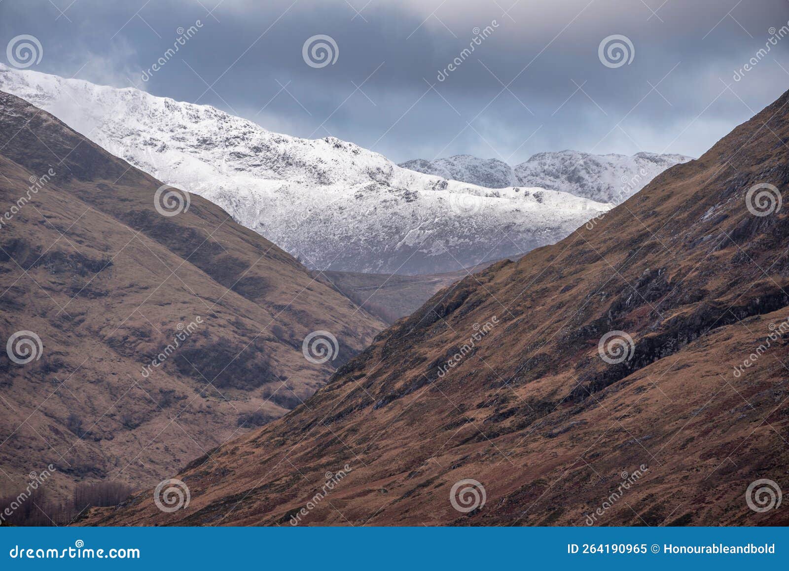 stunning winter landscape image of snowcapped three sisters mountain range in glencoe scottish highands with dramatic sky