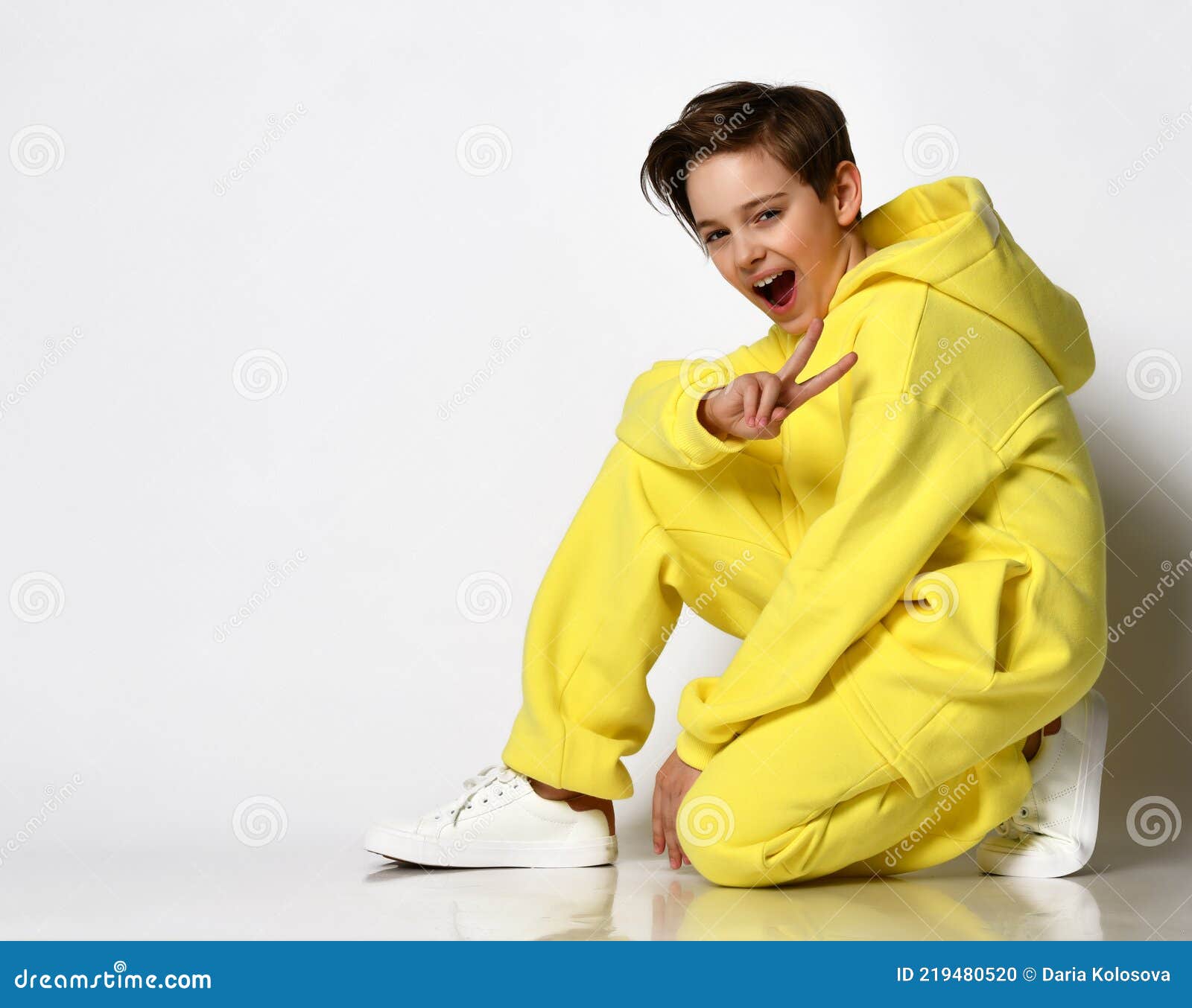 Stylish Active Guy in a Bright Yellow Sports Suit Having Fun on a White  Background. Stock Photo - Image of beautiful, sport: 219480520