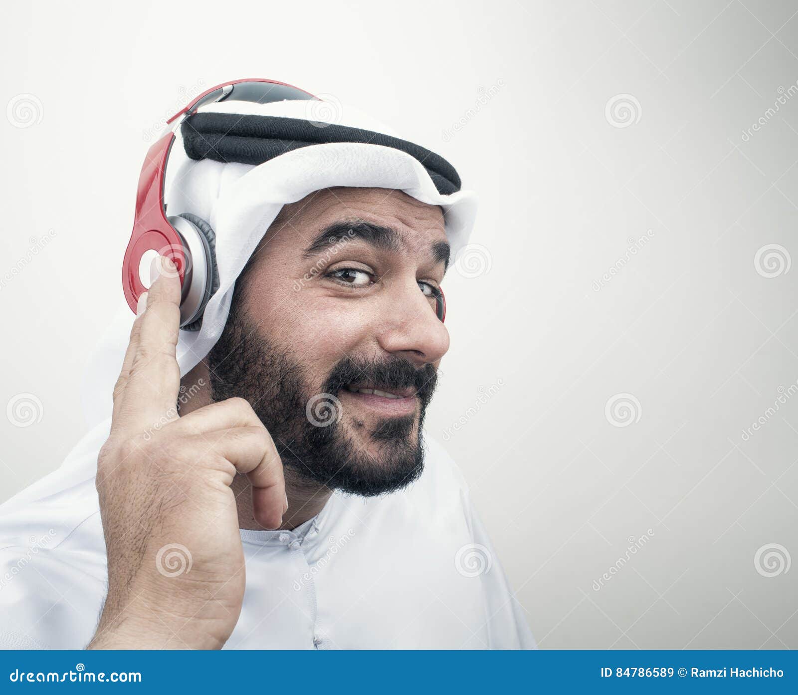 stylish arabian man in headphones, arabian guy listening to music..