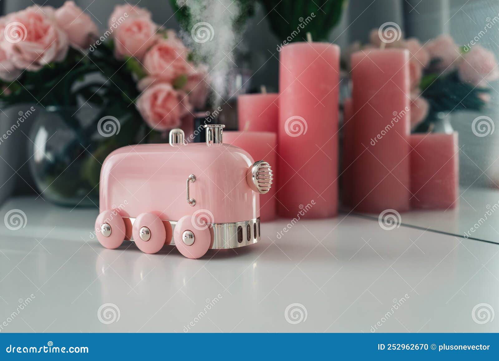 stylish aroma diffuser in the  of a steam locomotive on the table. women`s space, a cozy workplace