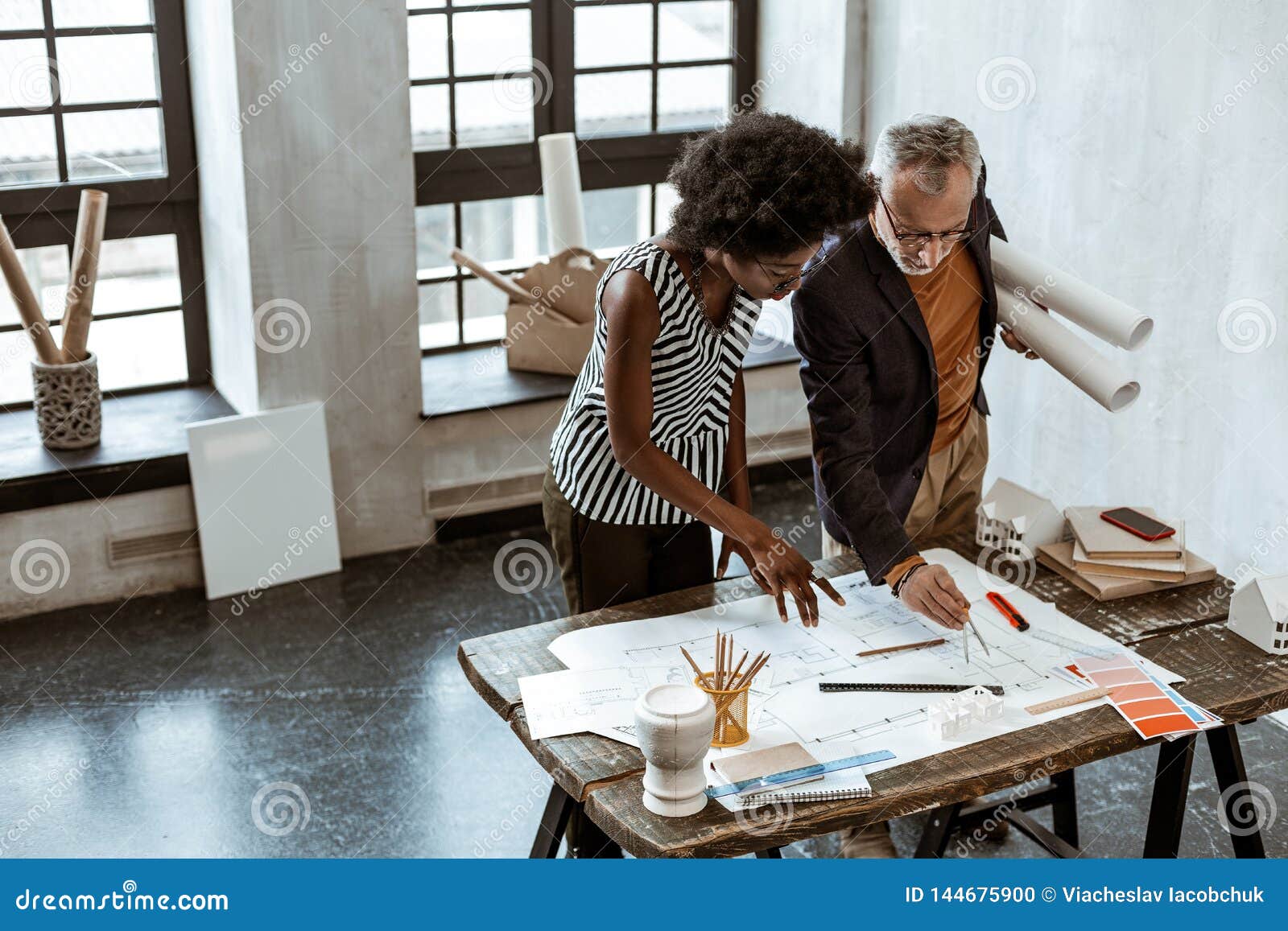 AfricanAmerican Stylish Assistant Of Interior Designer Helping Boss