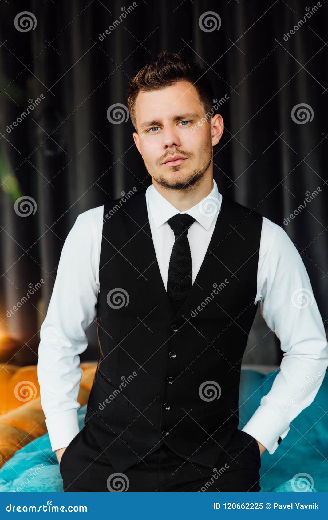 Stylish Athletic Man in a Business Costume Vest. Sits in the Turquoise ...