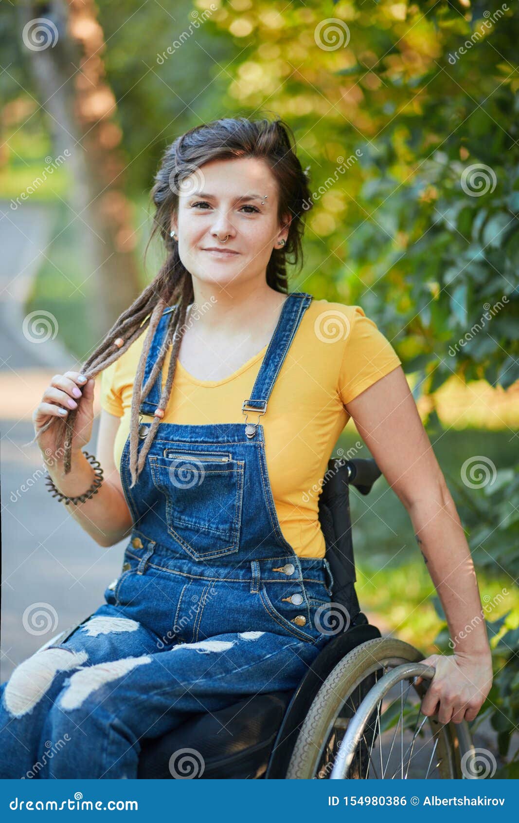 An attractive hipster girl in casual clothes sitting on an urban