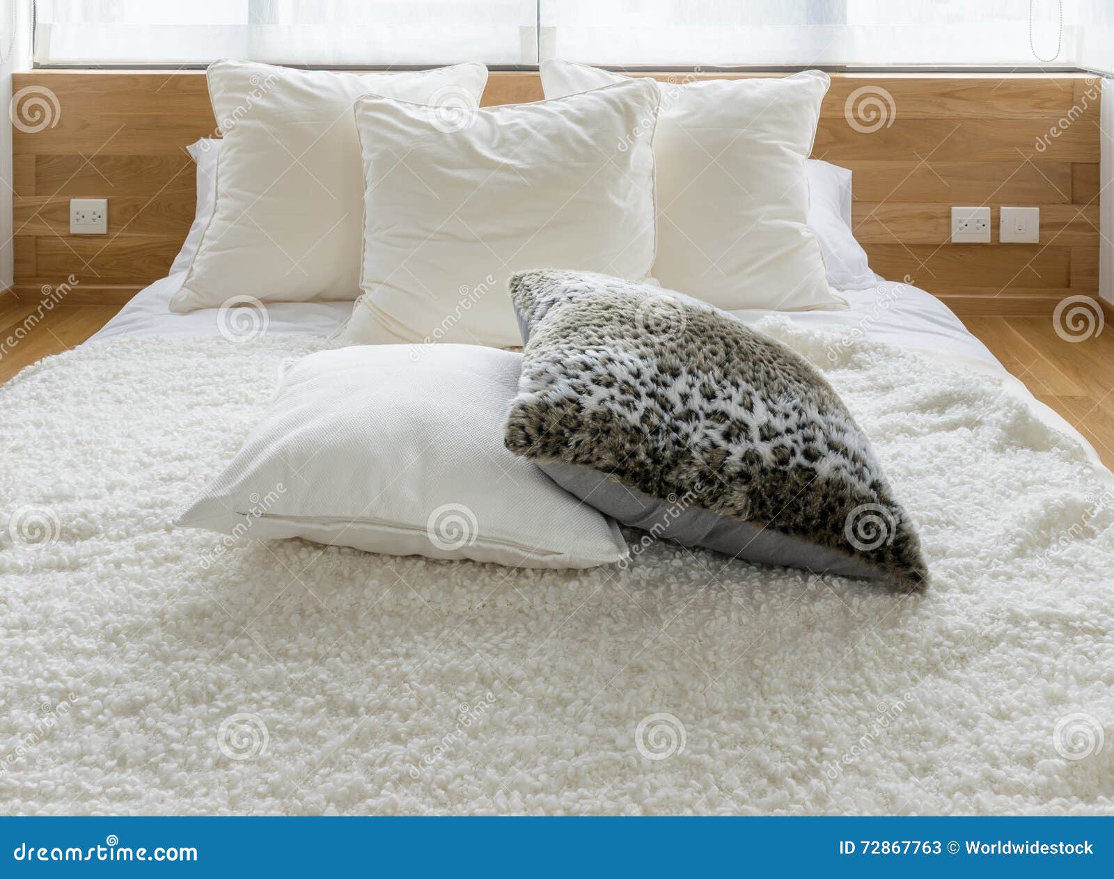 Stylish Bedroom Interior with Black and White Pillows on Bed Stock