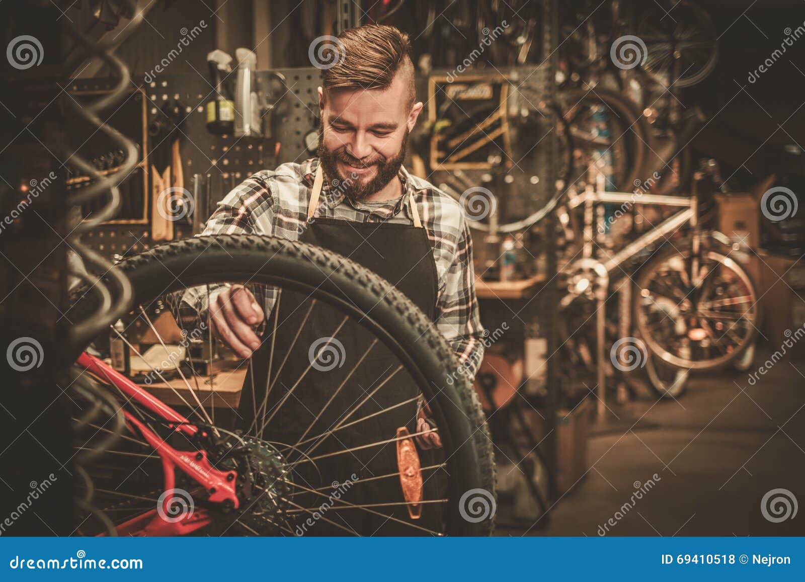 Stylish Bicycle Mechanic Doing His Professional Work in Stock