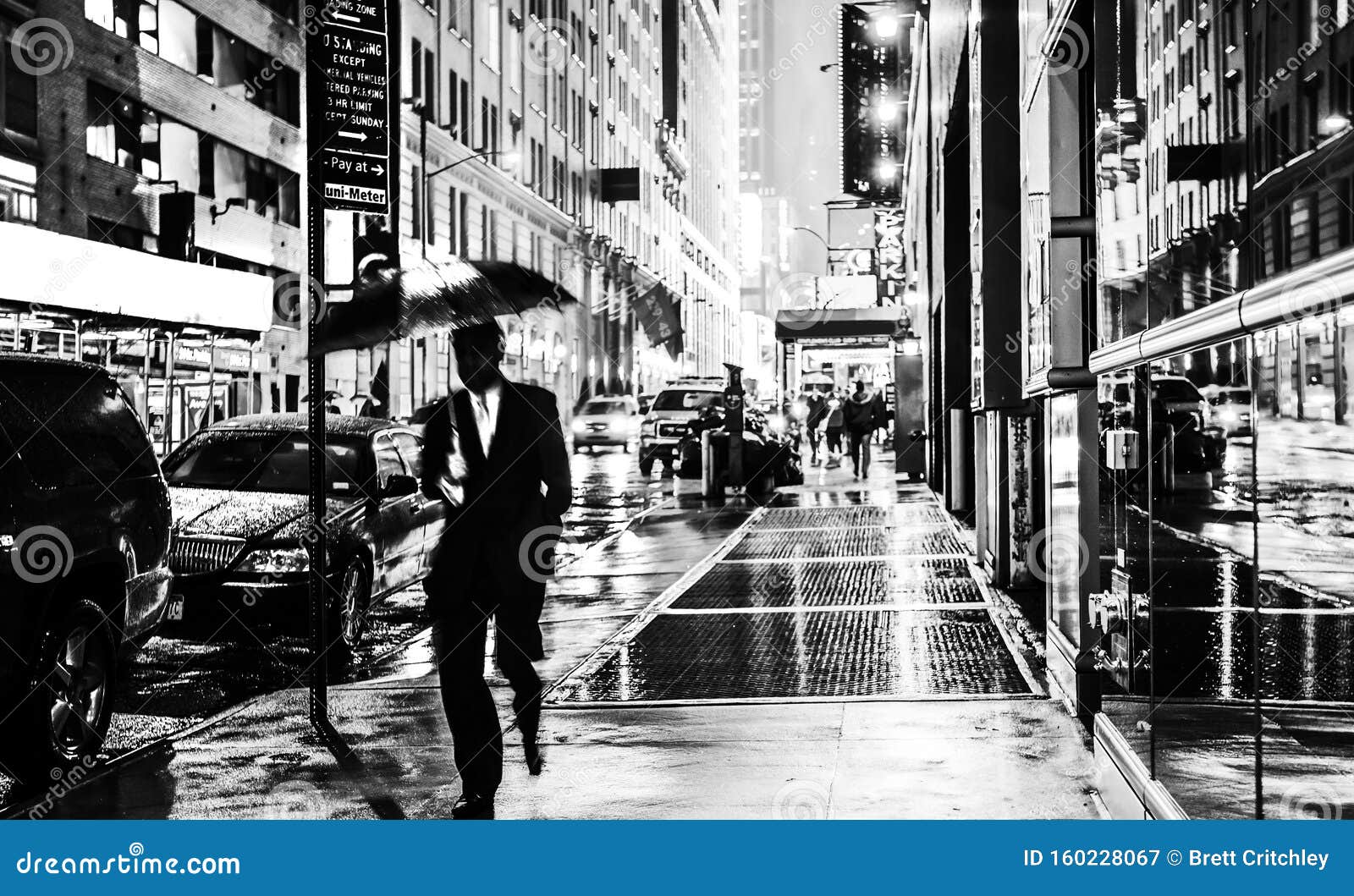 stylish black and white wet new york nyc commuter with umbrella