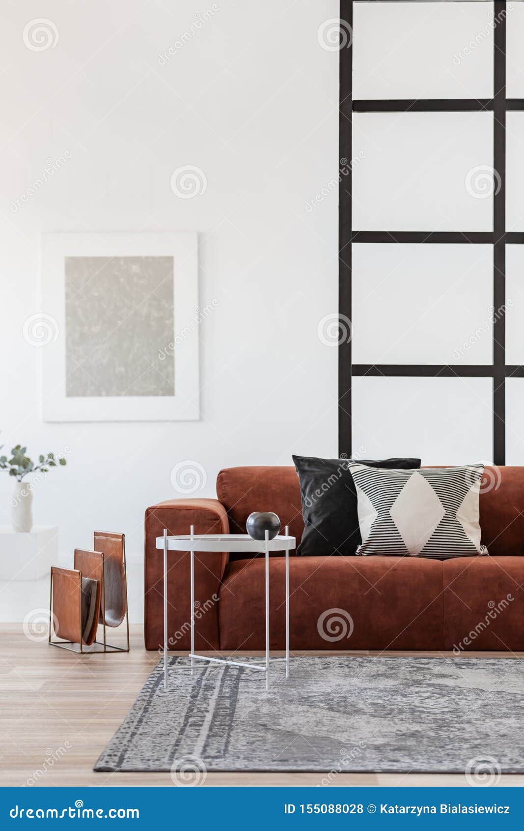 Stylish Brown Corner Sofa with Patterned Pillows in Elegant Living Room Interior with Mullions