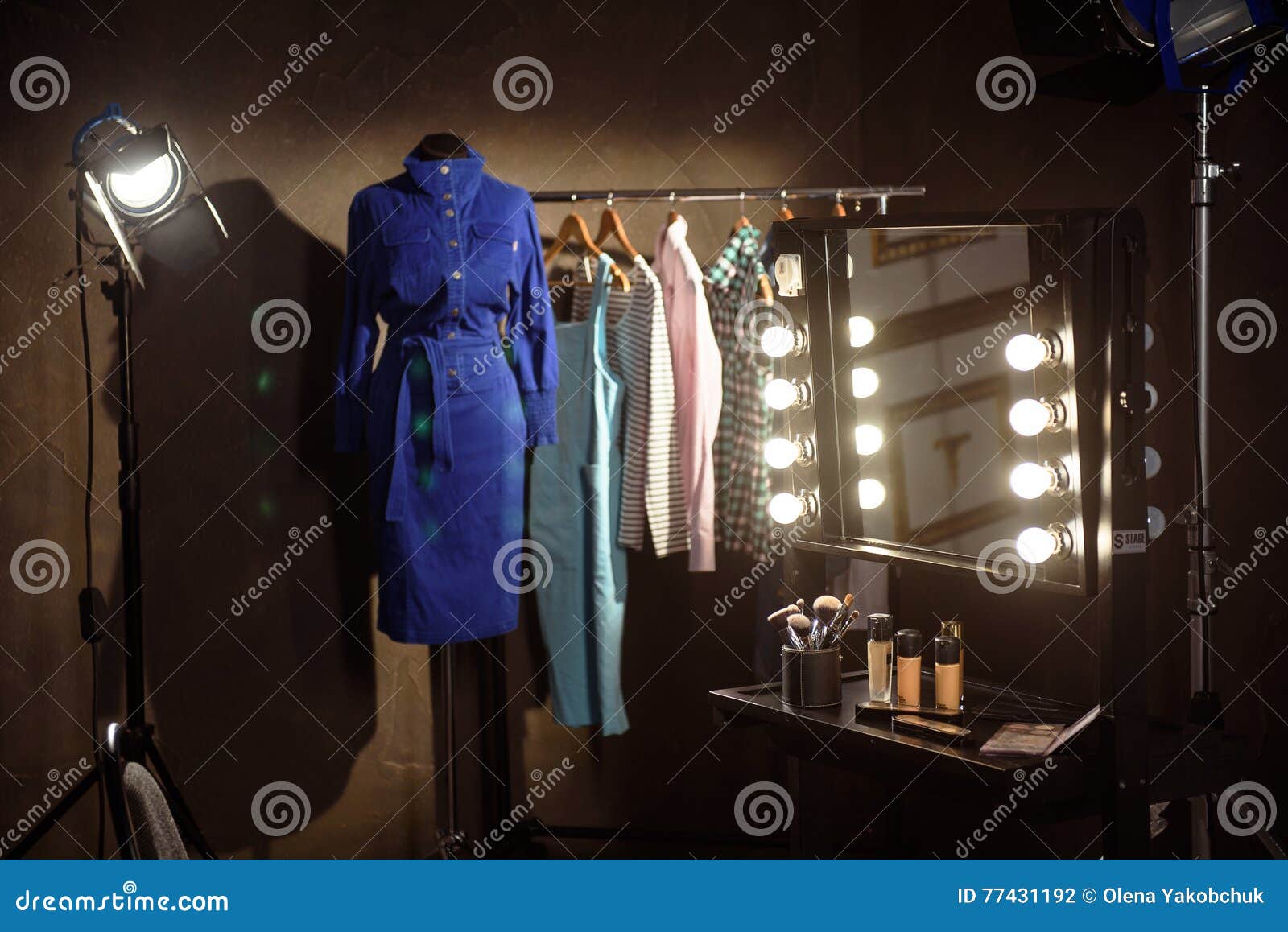 stylish clothes and make-up products in dressing room