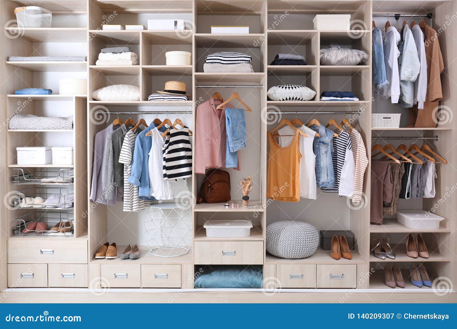 stylish clothes, shoes and home stuff in large wardrobe