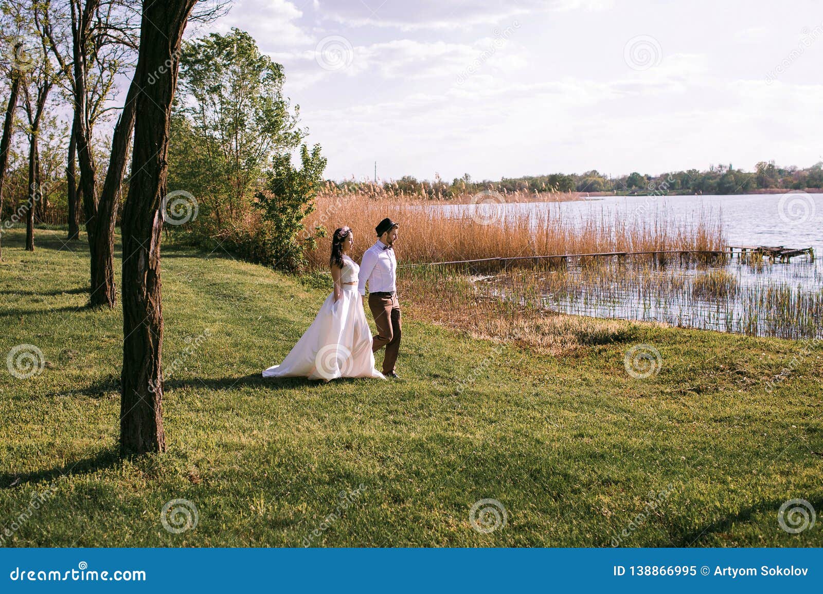 Stylish Couple on the River Bank with Reeds, the Bride and Groom Go To ...