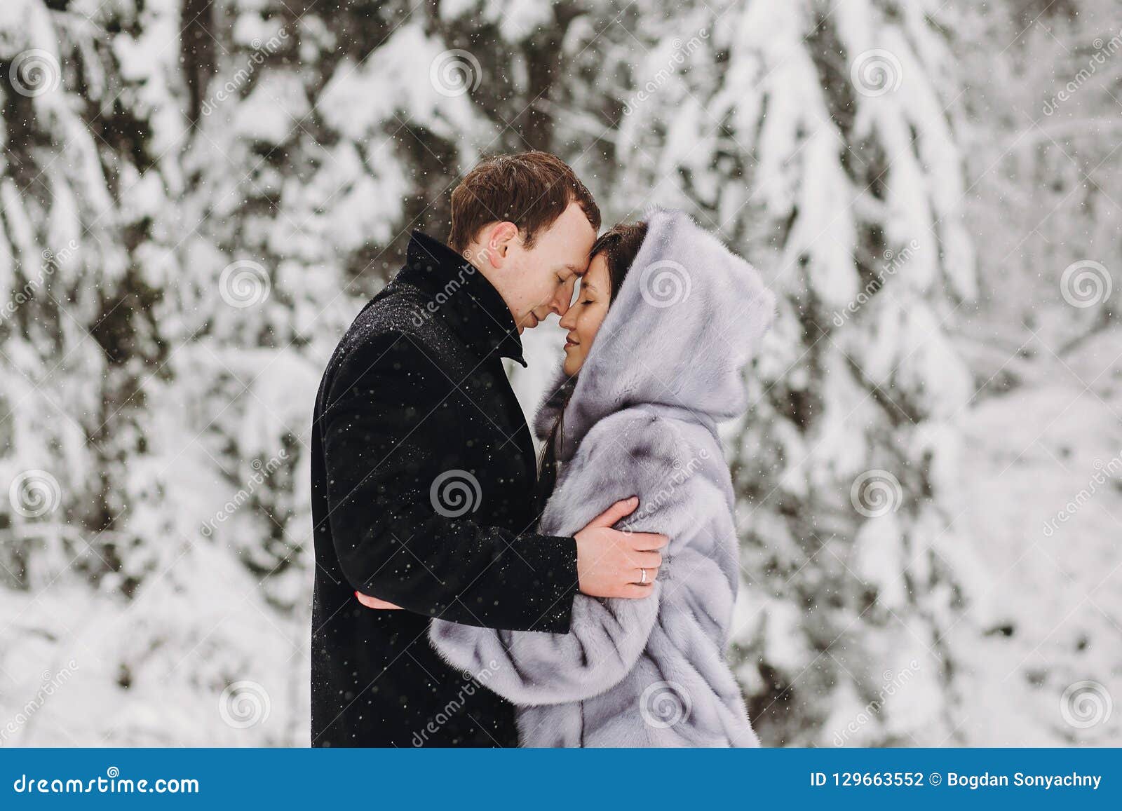 Stylish Couple Embracing in Winter Snowy Mountains. Happy Romantic ...