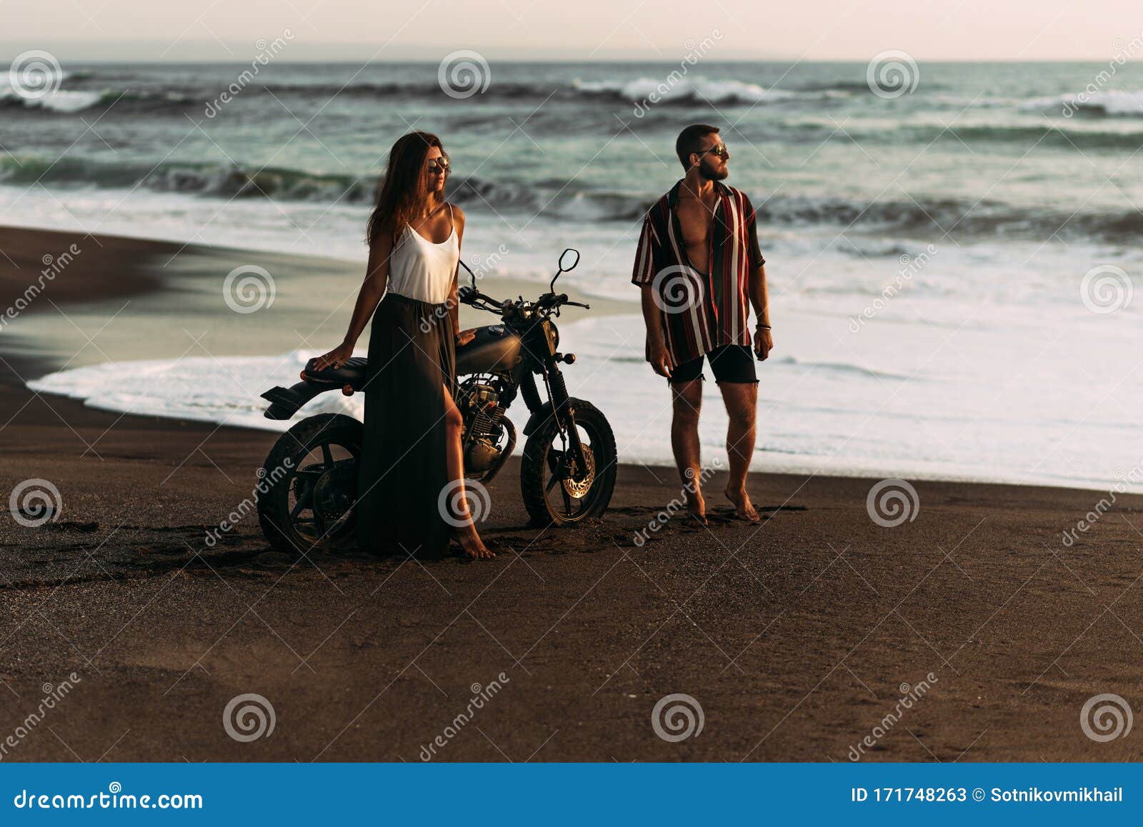 couple on motorcycle sunset