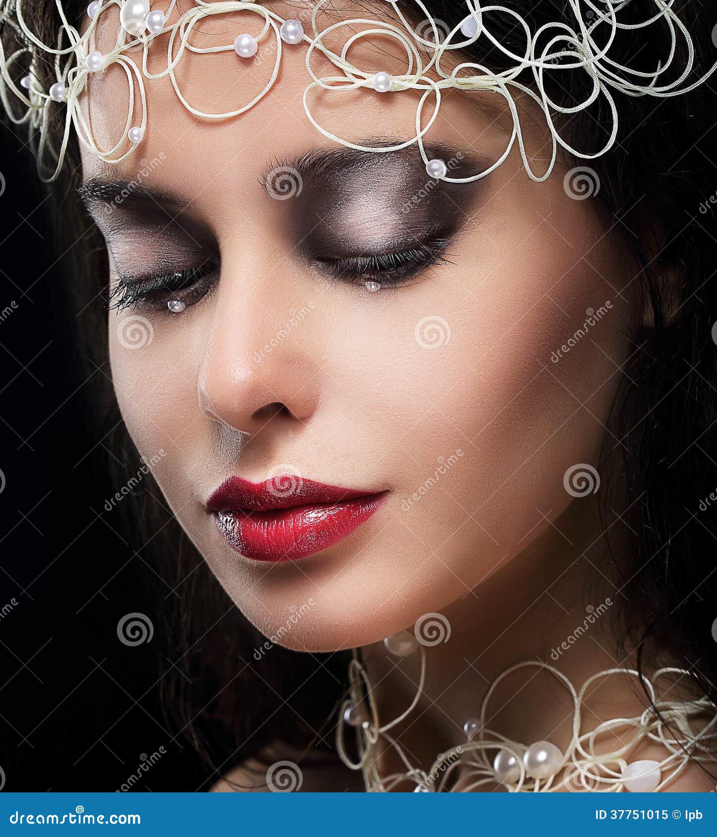 stylish fashionable young woman with pearls in reverie