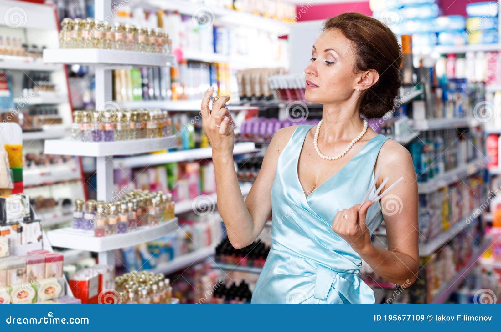 Female Smelling Perfume Testers, Choosing Perfume in Store Stock Image