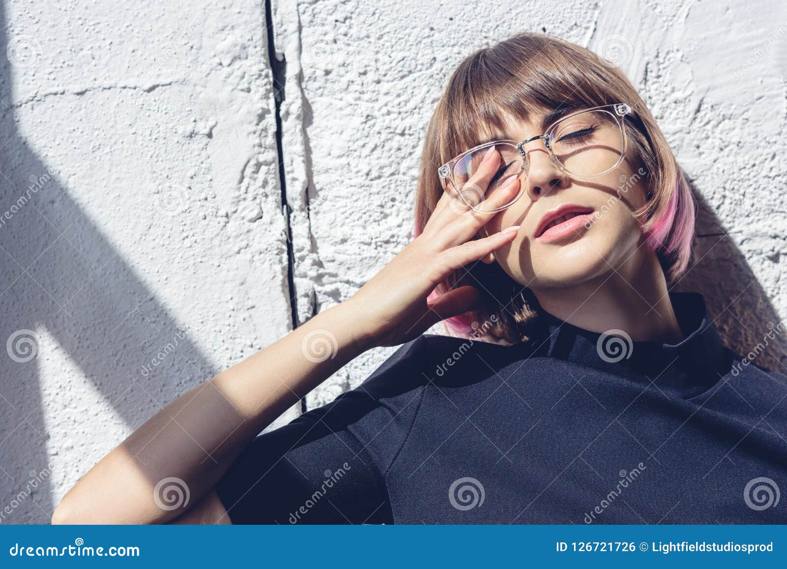 Stylish Girl Touching Eye with Hand and Leaning Stock Photo - Image of ...