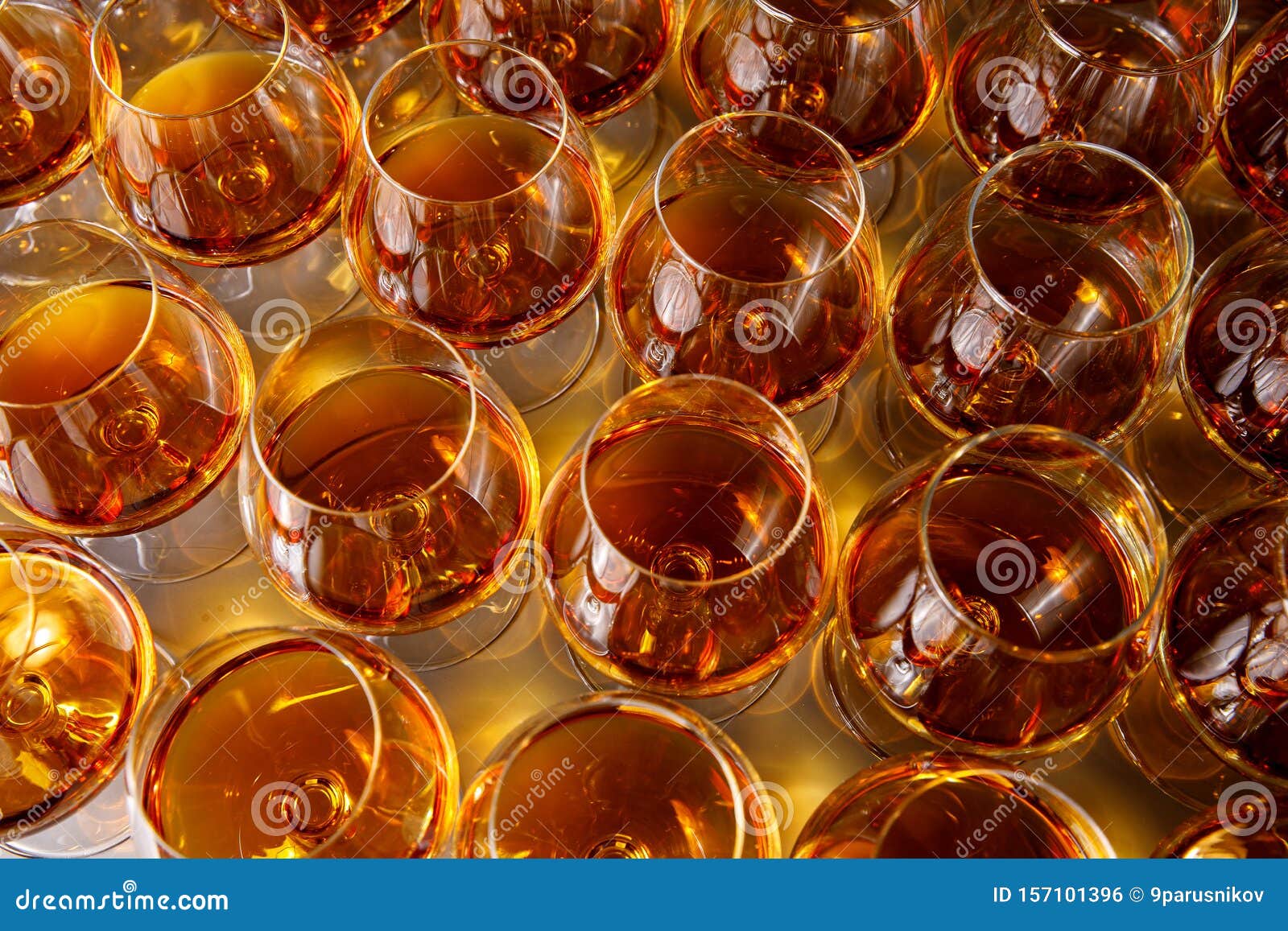 Stylish Glasses with Cognac or Whiskey on Table at Event Catering Stock